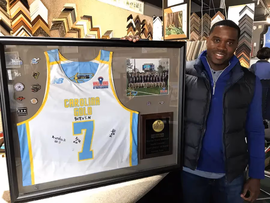 Framed jersey, medal and photograph